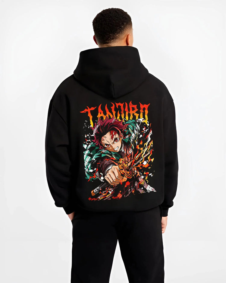 Black hoodie worn by male model from the back featuring Tanjiro Kamado flame sword Hinokami battle Demon Slayer artwork.