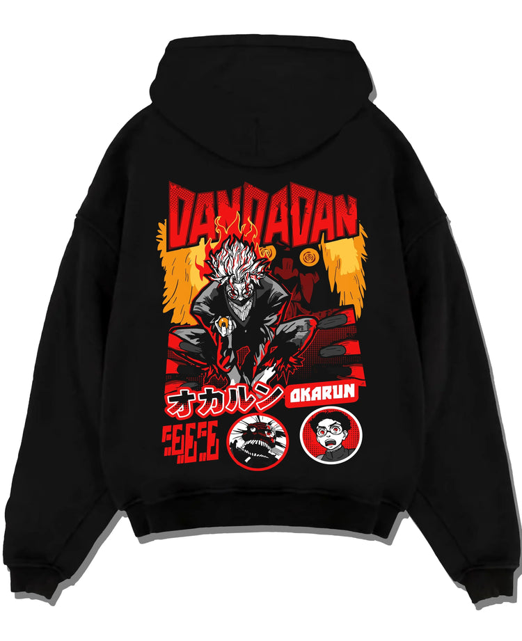 Black pullover hoodie laid flat with Okarun Hoodie Dandadan Possessed Spirit Alien Fight graphic premium wear.
