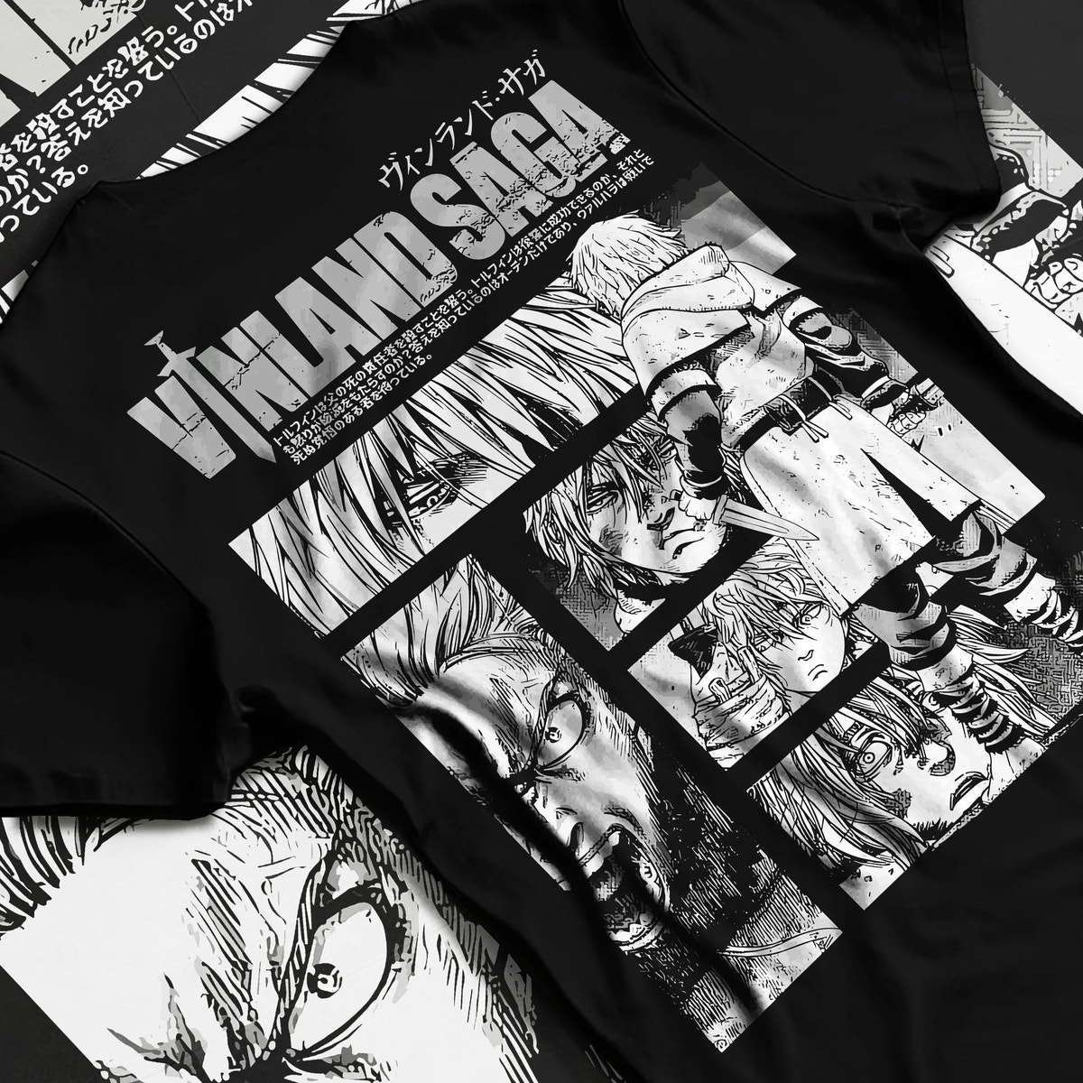 Black T-shirt flat back view showing Vinland Saga: black-and-white character collage