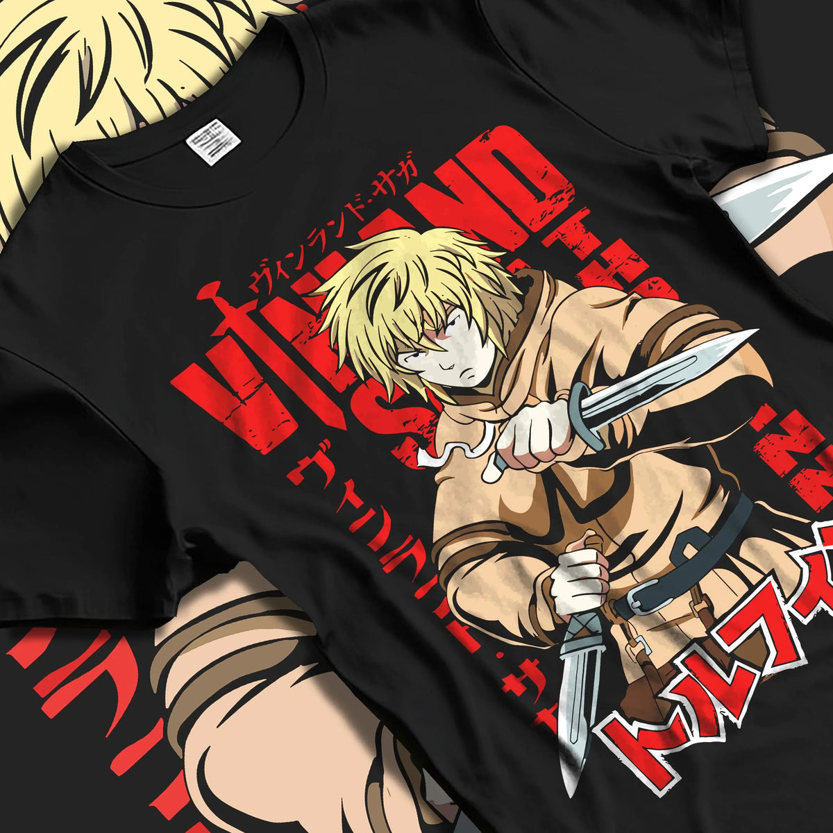 Black T-shirt laid flat with natural folds featuring Thorfinn dual daggers Viking warrior Vinland Saga artwork.
