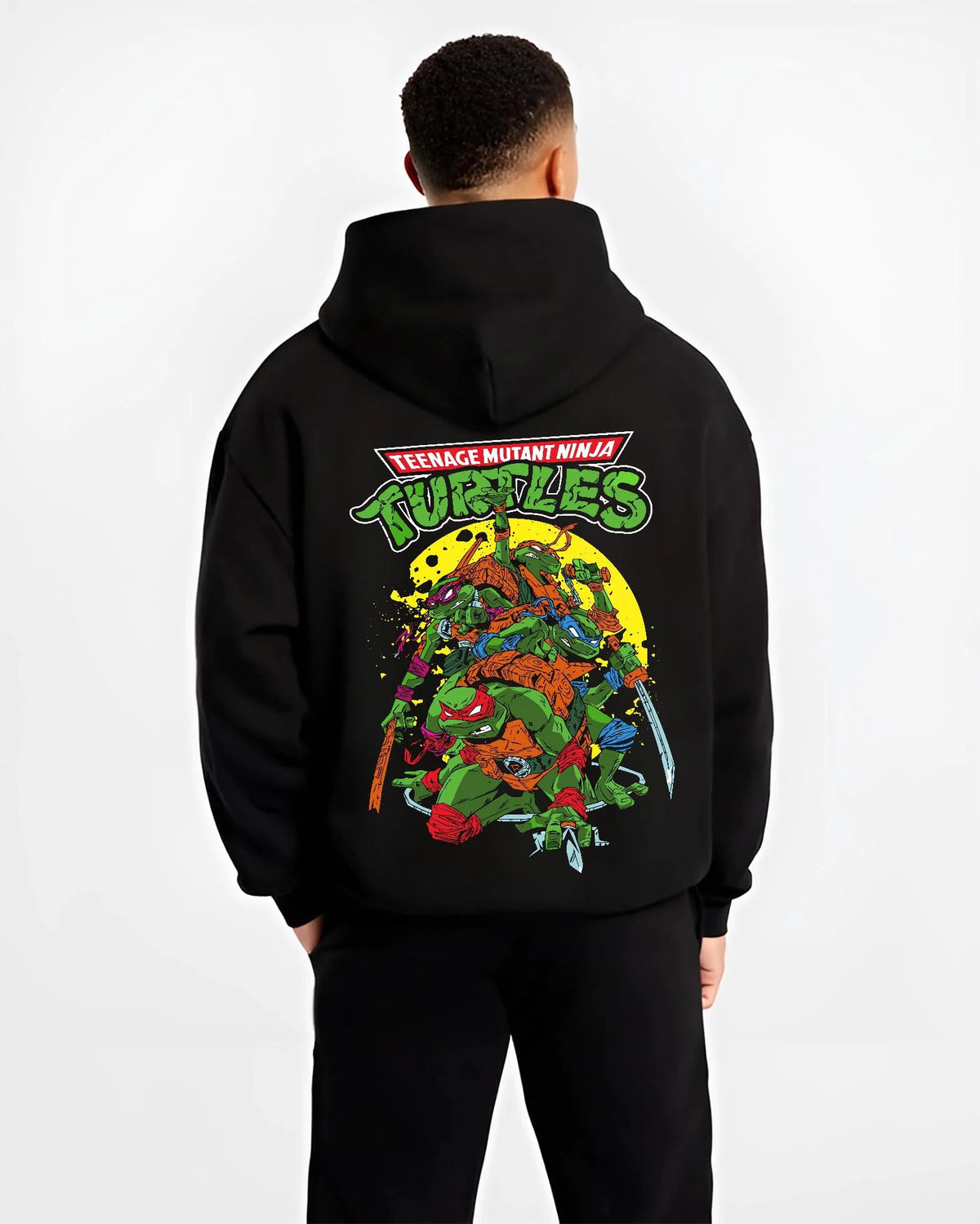 Black hoodie worn by male model from the back featuring Teenage Mutant Ninja Turtles heroes TMNT artwork.