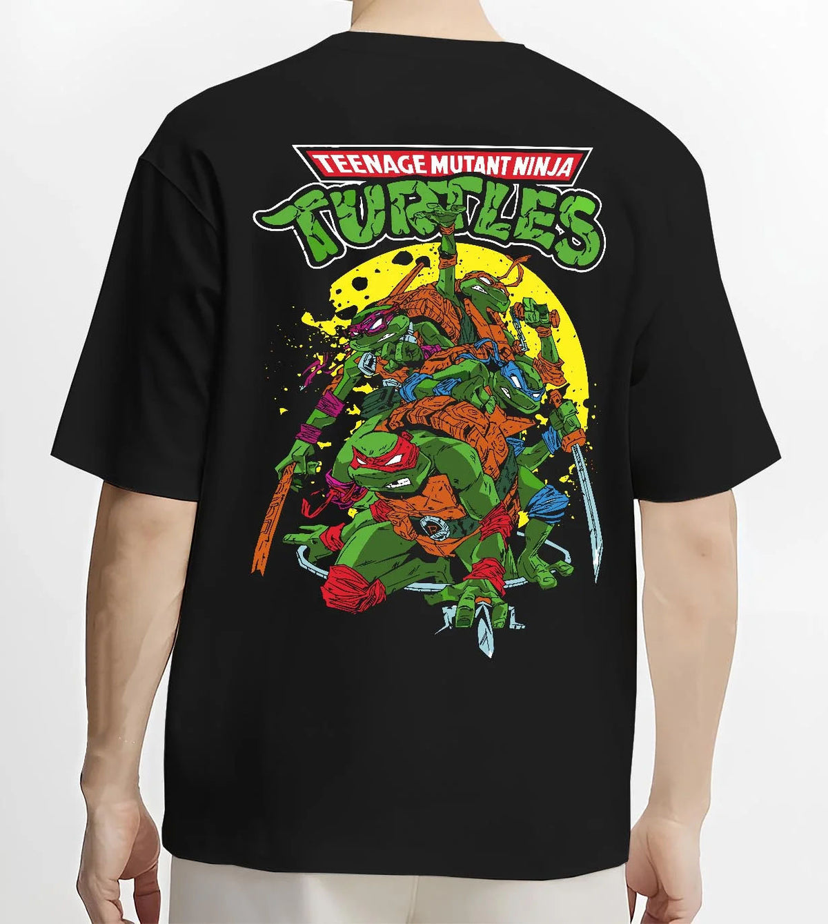 Black T-shirt worn by male model from the back featuring Teenage Mutant Ninja Turtles heroes TMNT artwork.