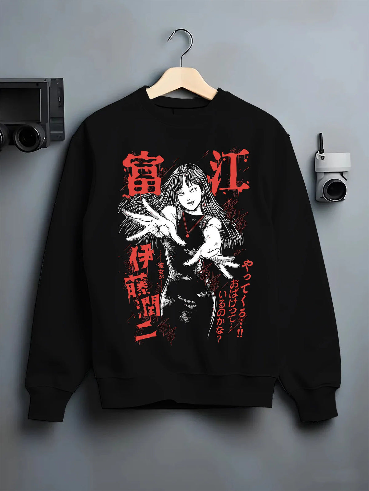 Black crewneck sweatshirt on hanger showing Tomie Kawakami from Junji Ito: raised hands and horror portrait