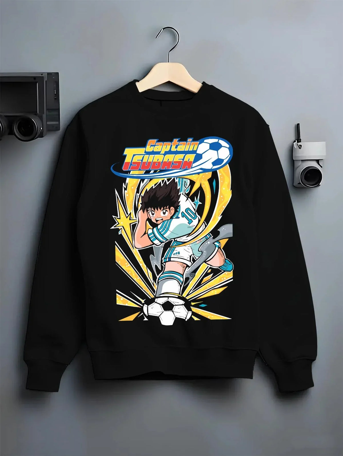 Black crewneck sweatshirt on hanger with Tsubasa Hoodie Captain Tsubasa Soccer Kick Classic graphic streetwear graphic.