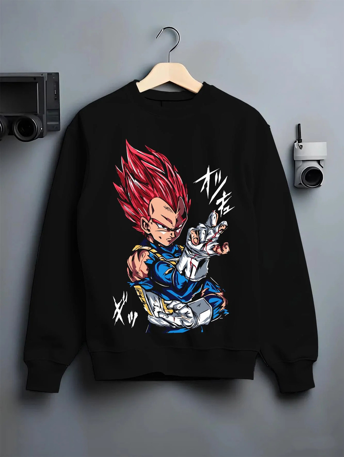 Black crewneck sweatshirt on hanger featuring Vegeta Super Saiyan God red aura Dragon Ball Super artwork.