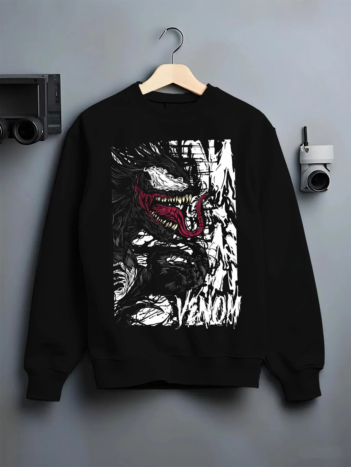 Black crewneck sweatshirt on hanger featuring Venom white symbiote monster portrait Marvel artwork.