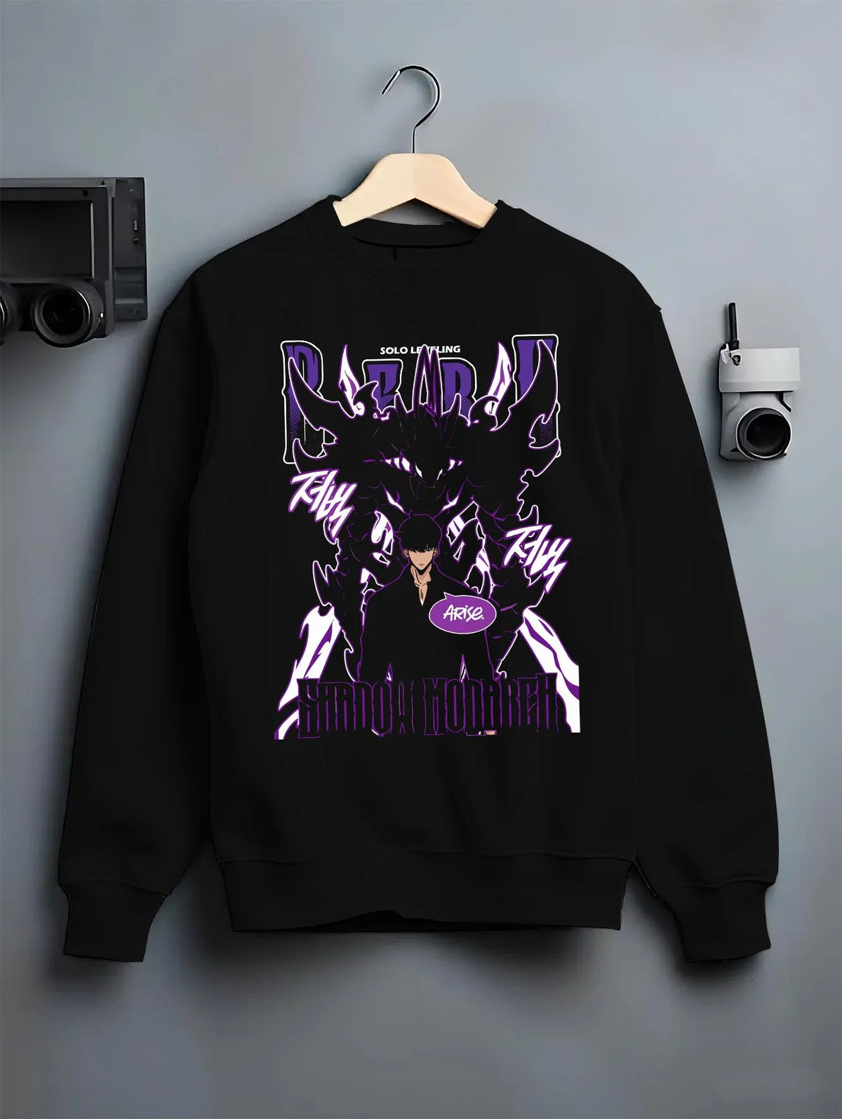 Black crewneck sweatshirt on hanger featuring Sung Jin-Woo Shadow Monarch purple aura Solo Leveling artwork.