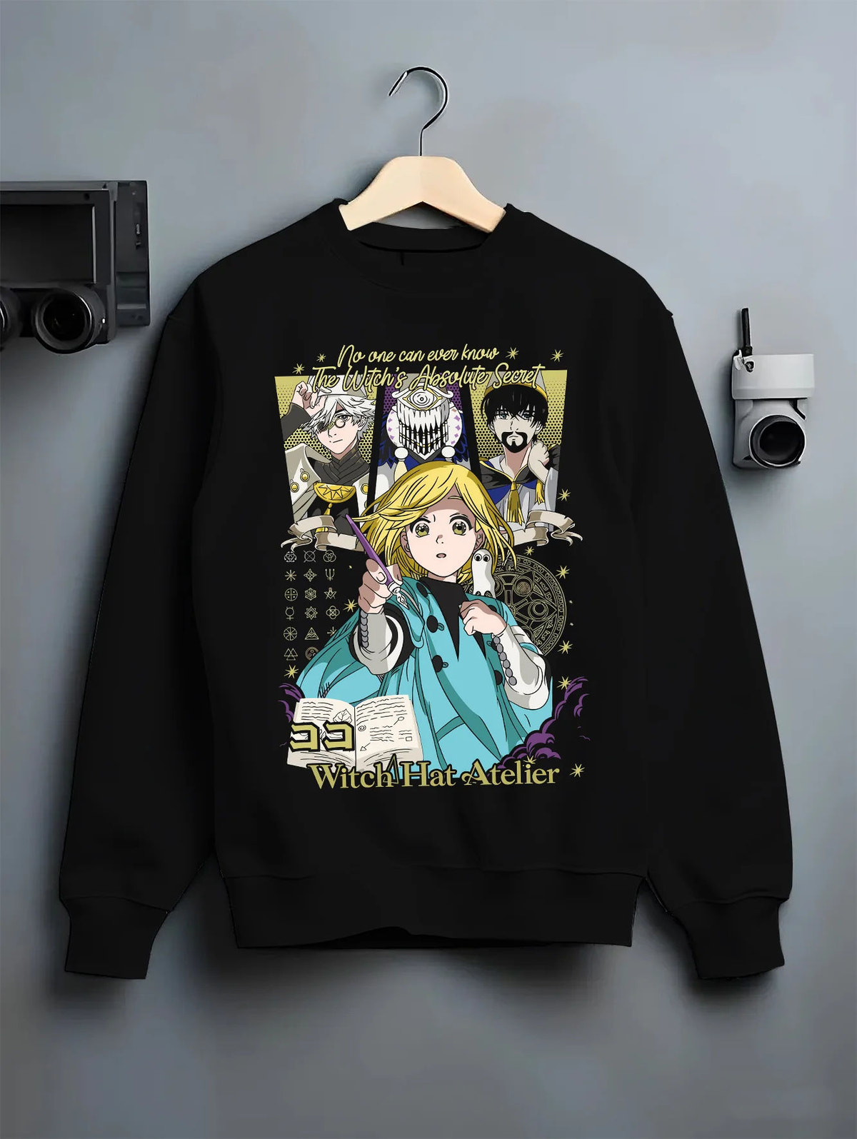 Black crewneck sweatshirt on hanger showing Witch Hat Atelier: Coco and supporting characters