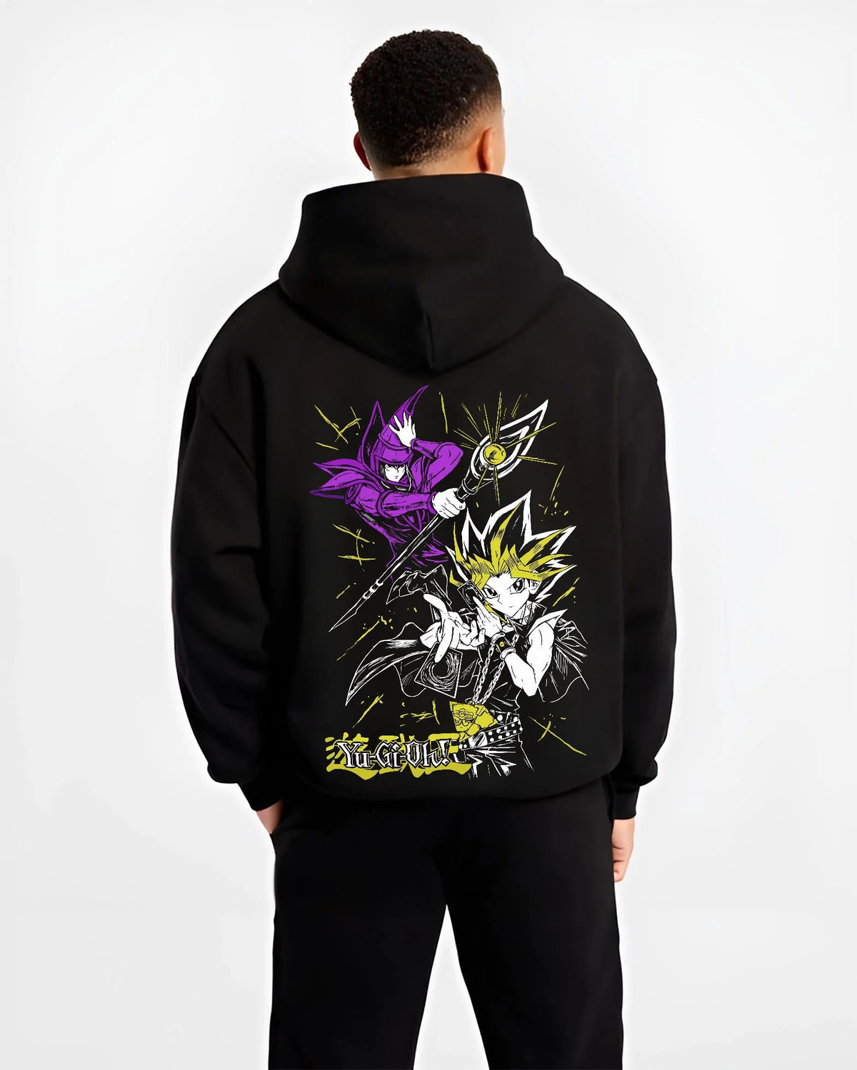 Black hoodie worn by male model from the back featuring Yugi Millennium Puzzle King of Games Yu-Gi-Oh! artwork.