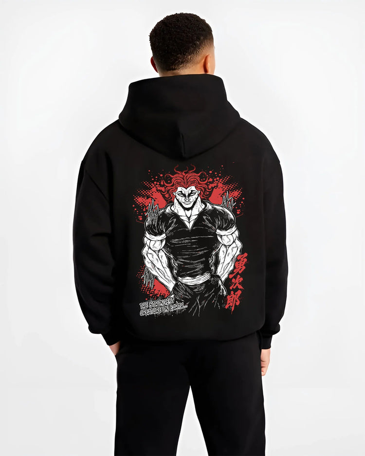 Black hoodie model back view with Yujiro Hanma (muscular, red-haired portrait) from Baki illustrated back graphic