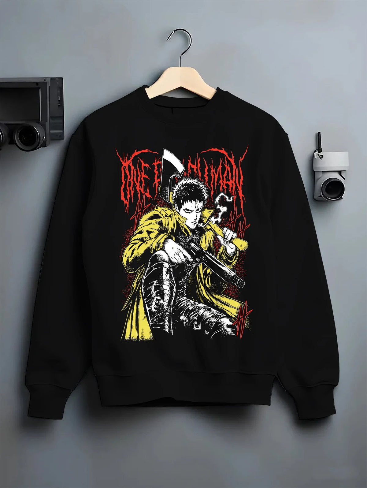 Black crewneck sweatshirt on hanger showing Zombieman from One Punch Man: seated firearm pose