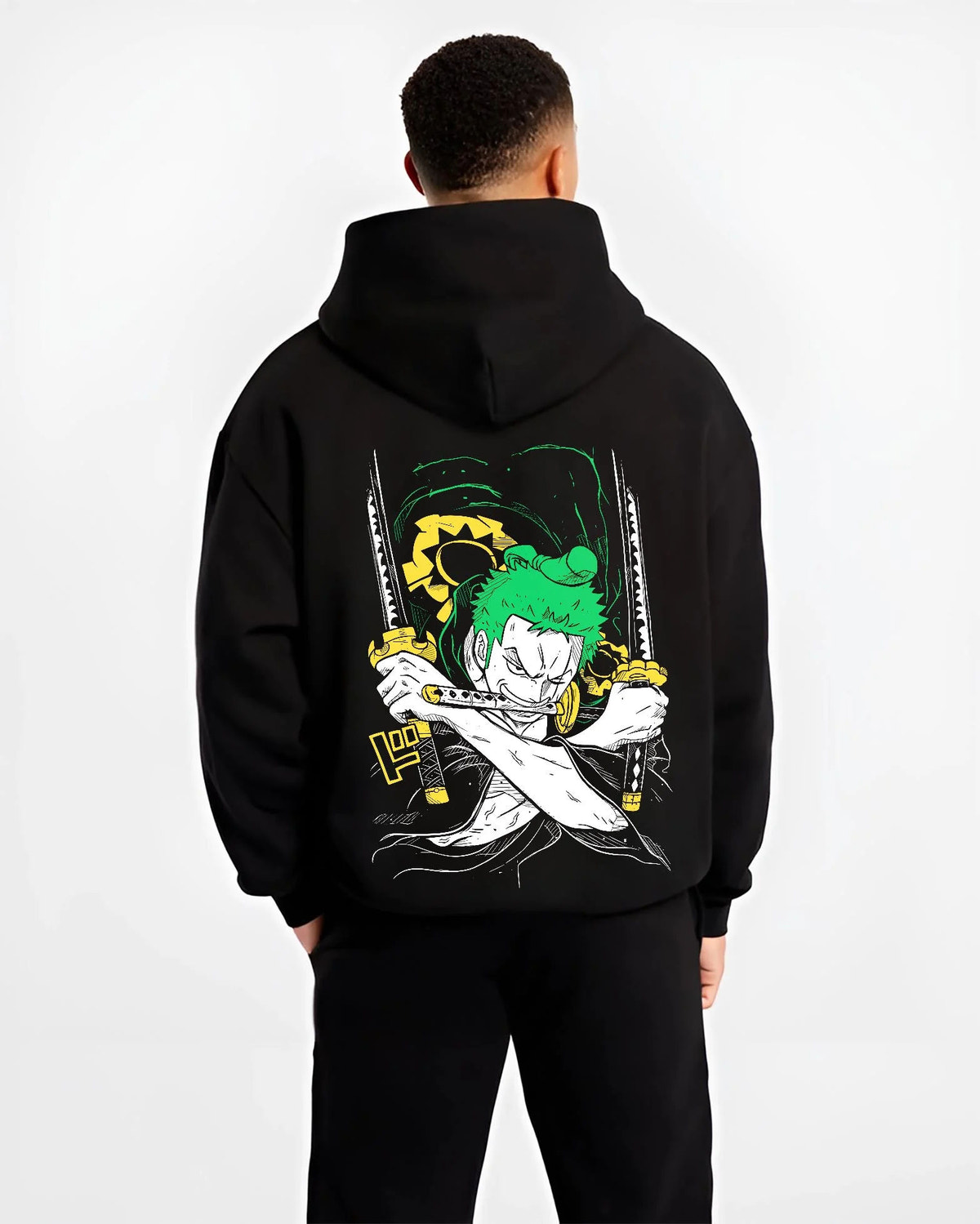 Black hoodie worn by male model from the back featuring Roronoa Zoro Santoryu green sword One Piece artwork.