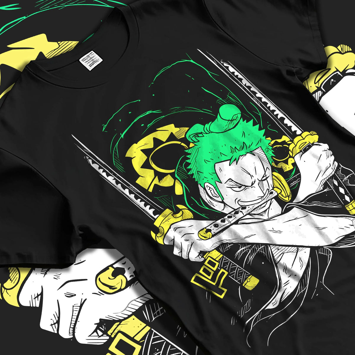 Black T-shirt laid flat with natural folds featuring Roronoa Zoro Santoryu green sword One Piece artwork.