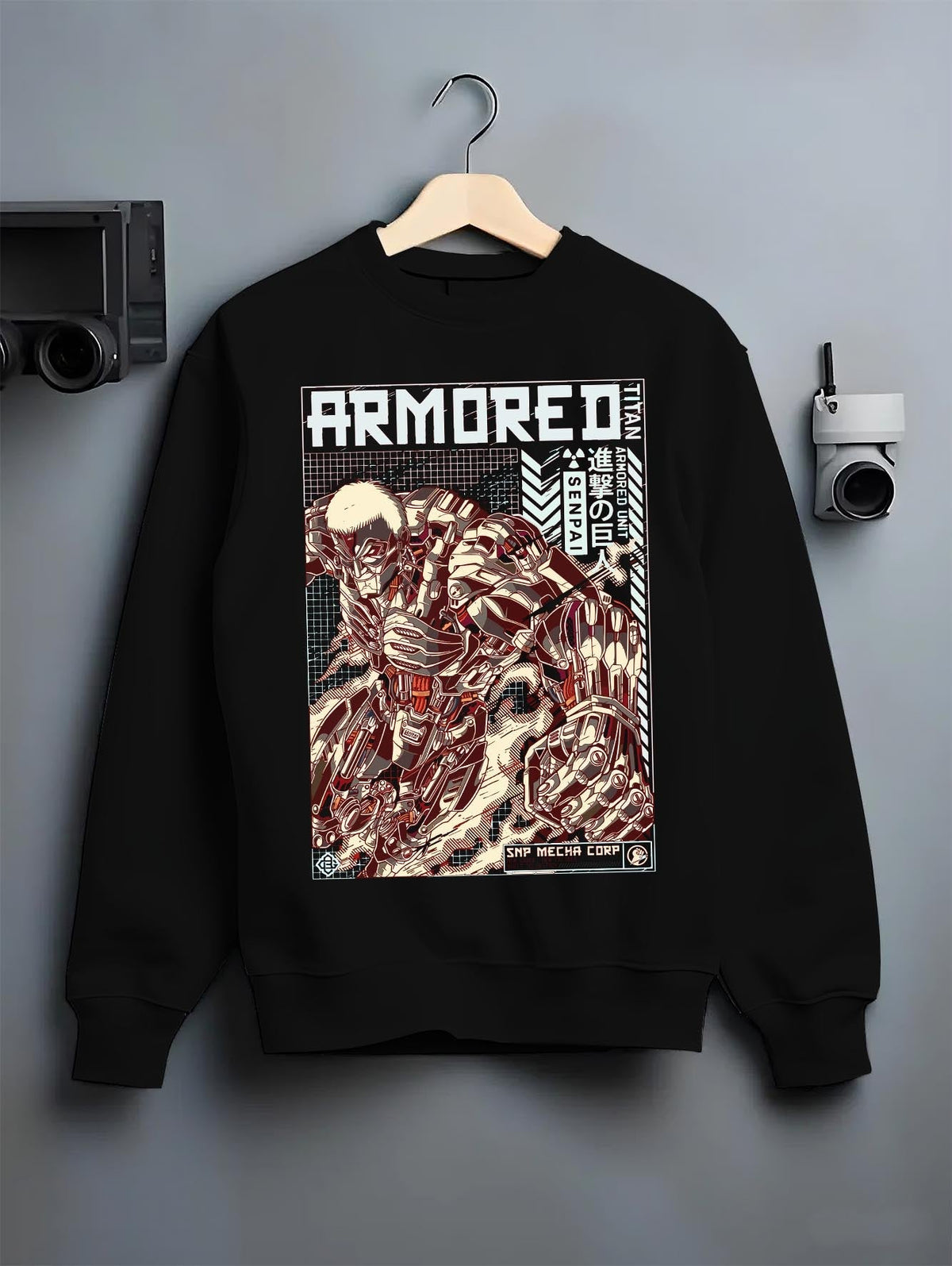 Black crewneck sweatshirt on a hanger against a grey wall, featuring Attack on Titan Armored Titan anime poster inspired design in retro mecha manga battle style.