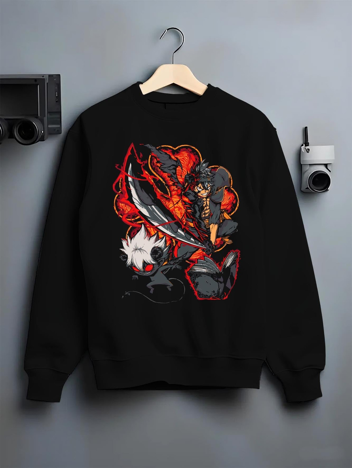 Black crewneck sweatshirt on a hanger against a grey wall, featuring Black Clover Asta anime poster inspired design with dark demon aura in fiery manga battle style.
