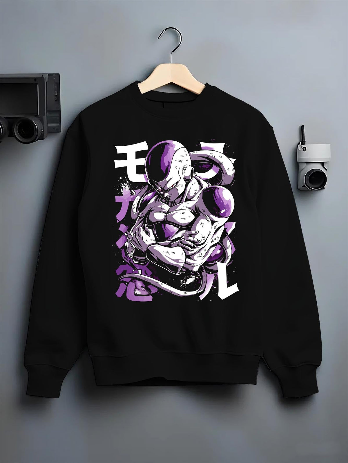 Black crewneck sweatshirt on a hanger against a grey wall, featuring Frieza Dragon Ball Z retro manga graphic with folded arms and bold purple villain aura artwork.