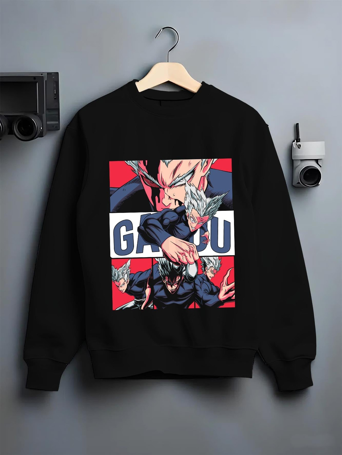 Black crewneck sweatshirt on hanger against grey wall, Garou retro manga panel back graphic with bold red blocks.