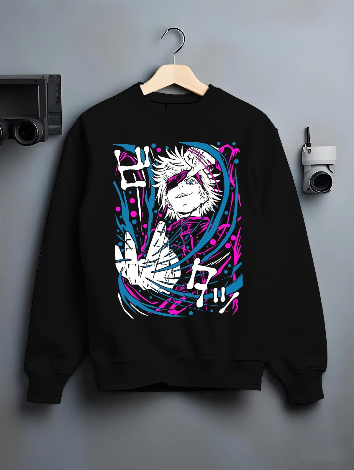Black crewneck sweatshirt on hanger against grey wall, Gojo anime poster back graphic with bright pink and cyan swirls.