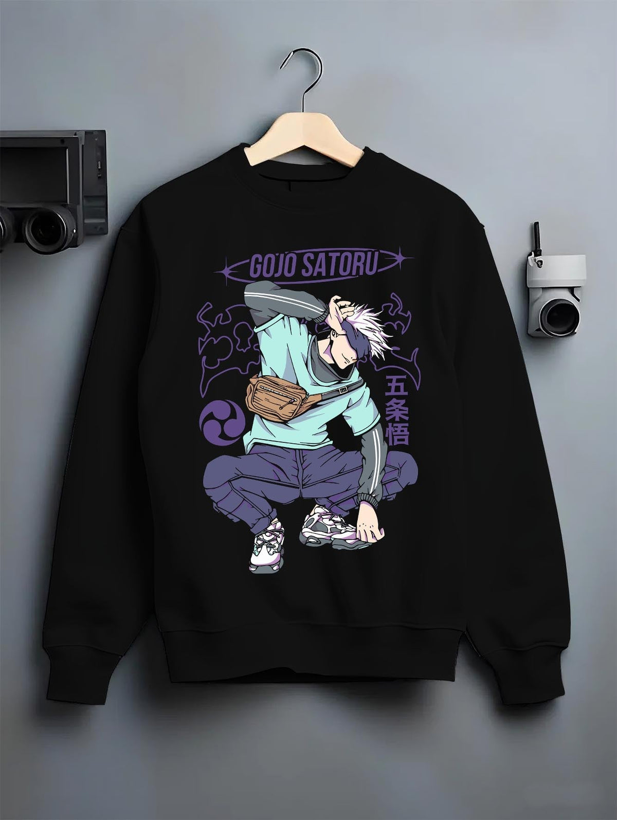 Black crewneck sweatshirt on hanger against grey wall, Gojo Satoru urban fashion back design with purple lettering, dynamic pose and clean manga styling.