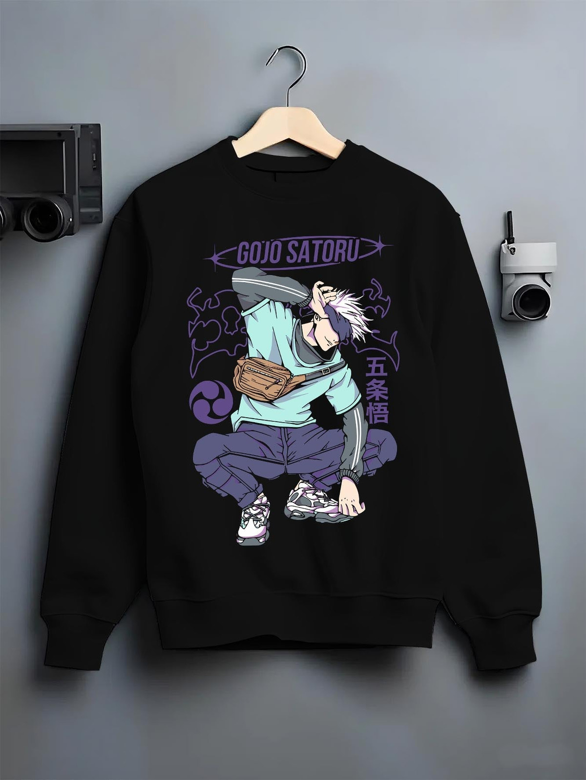 Black crewneck sweatshirt on hanger against grey wall, Gojo Satoru urban fashion back design with purple lettering, dynamic pose and clean manga styling.