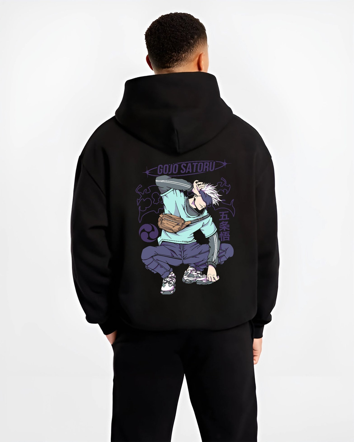 Black hoodie on male model, back view, featuring Gojo Satoru crouch pose, retro manga graphic, purple symbols and sling bag for Japanese streetwear flair.