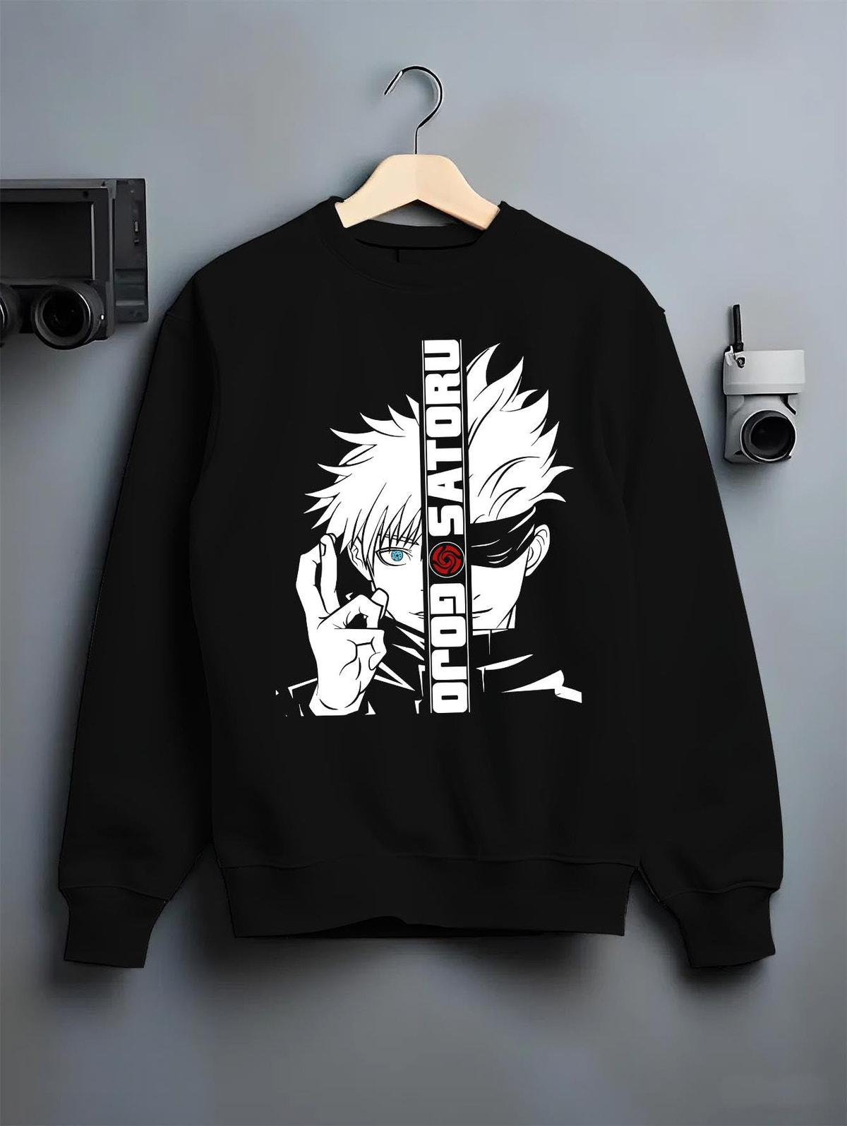 Black crewneck sweatshirt on hanger against grey wall, featuring Gojo Satoru split portrait anime poster graphic with high-contrast linework.