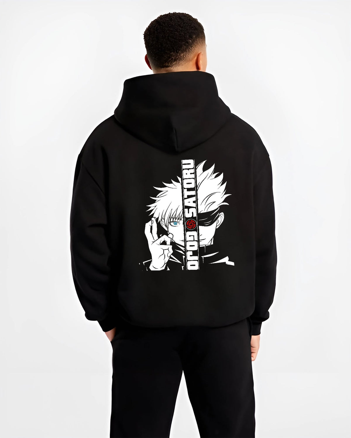 Black hoodie on male model, back view, featuring Gojo Satoru split portrait retro manga graphic with blue eye and urban streetwear flair.