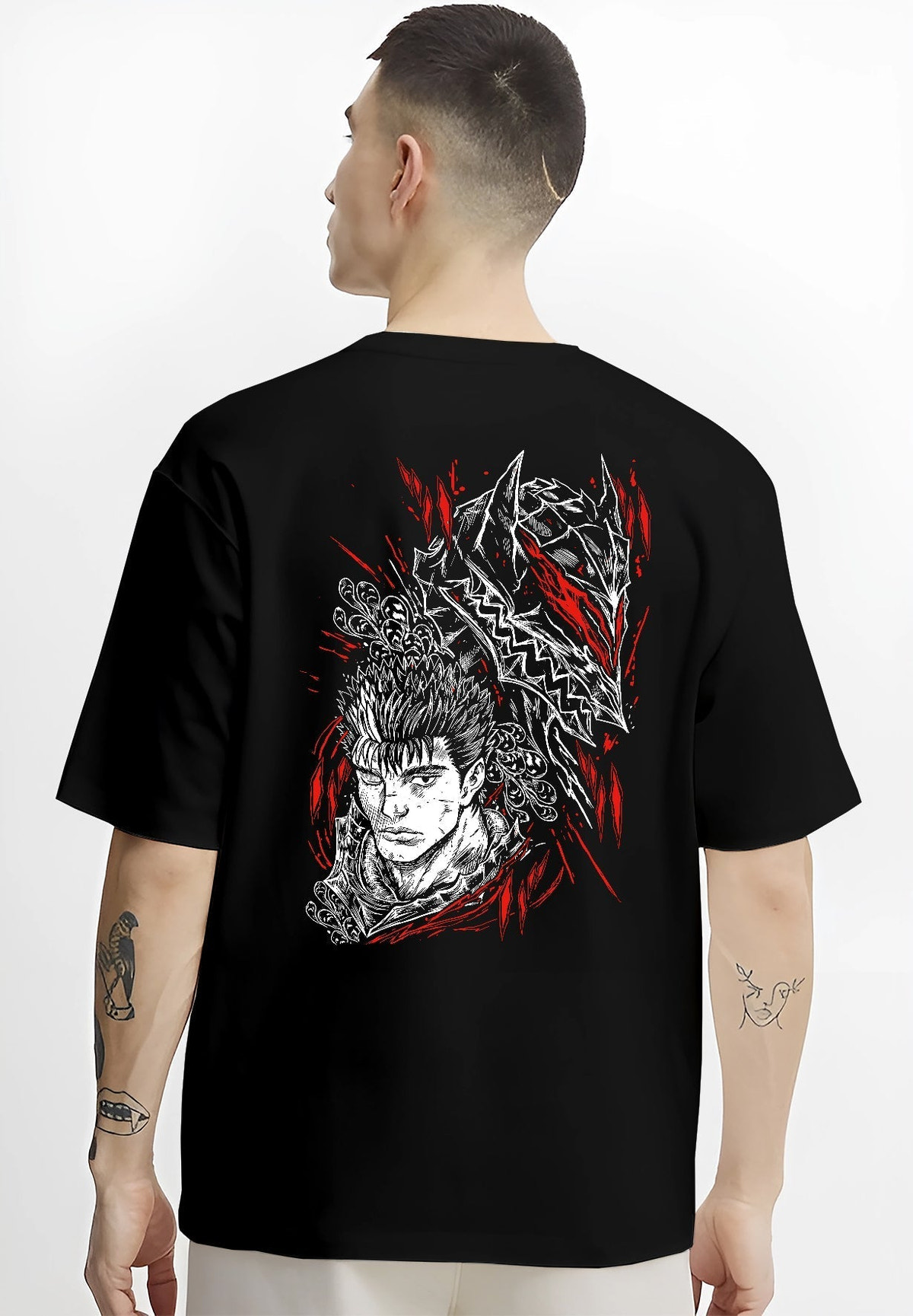 Black T-shirt worn by a male model, back view, featuring Guts Berserk anime poster inspired artwork in dark manga style with red battle aura.