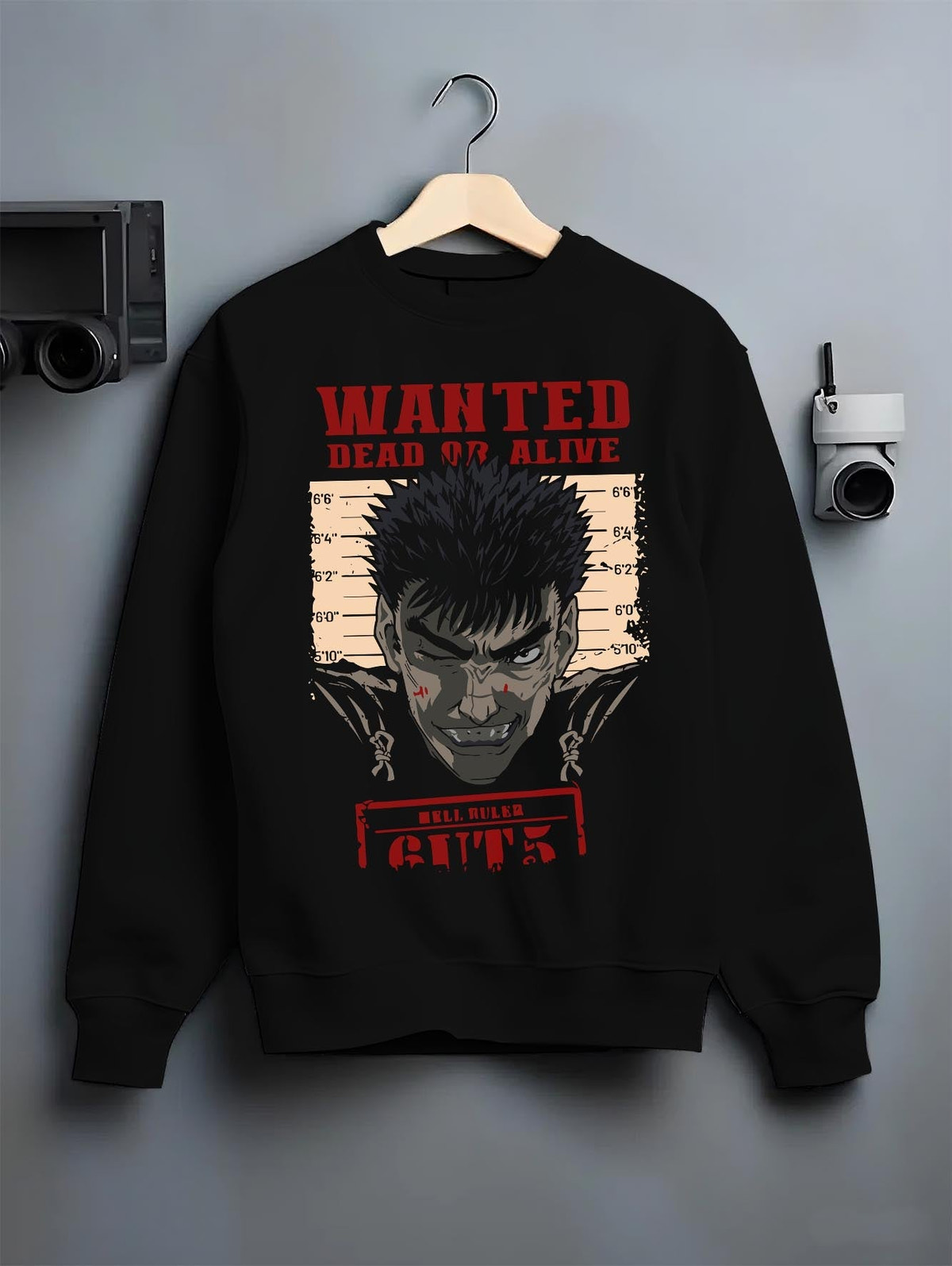 Black crewneck sweatshirt on a hanger against a grey wall, featuring Berserk retro manga wanted poster of Guts with striking red anime streetwear artwork.