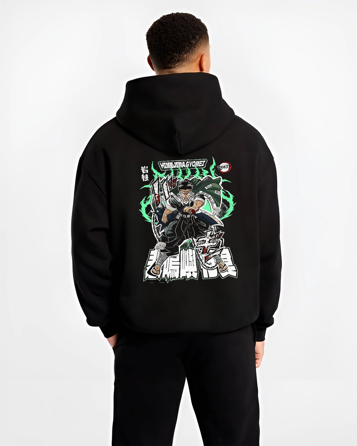 Black hoodie worn by a male model, back view, featuring Himejima Demon Slayer Japanese animation streetwear design with shonen battle stance and vivid green energy aura.