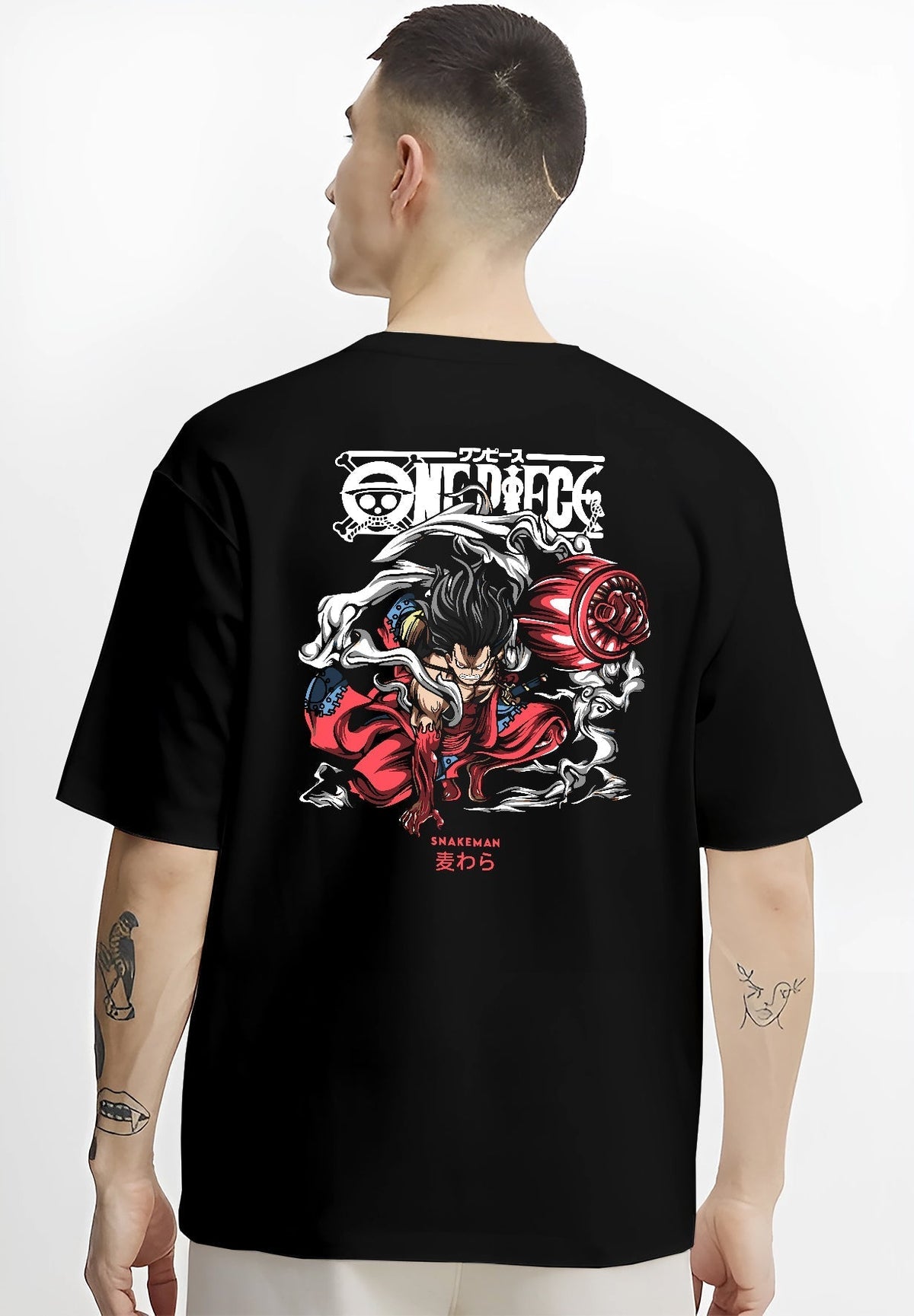 Black T-shirt on male model, back view, featuring One Piece Luffy Snakeman retro manga graphic with swirling smoke and vivid red details.