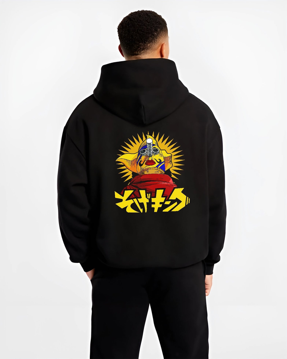 Black hoodie on male model, back view, featuring anime poster inspired masked idol graphic with sunburst rays and striking Japanese lettering.