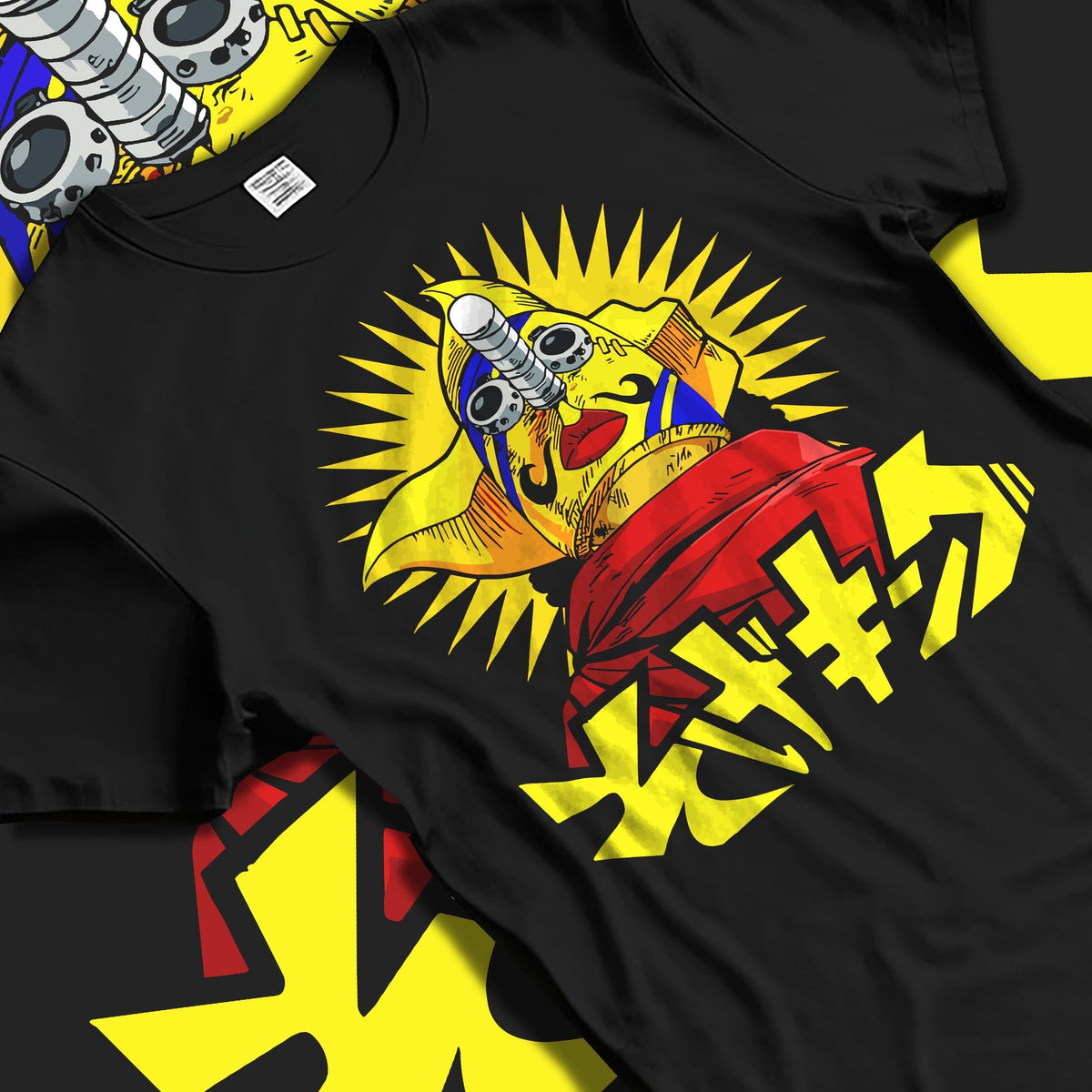 Black T-shirt laid flat with natural folds, featuring nostalgic 90s graphic of a masked idol with bright sunburst and Japanese lettering.