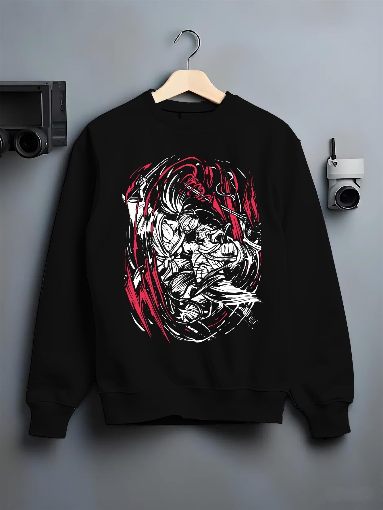 Black crewneck sweatshirt on hanger against grey wall, Rurouni Kenshin Samurai X back graphic with red slash accents.