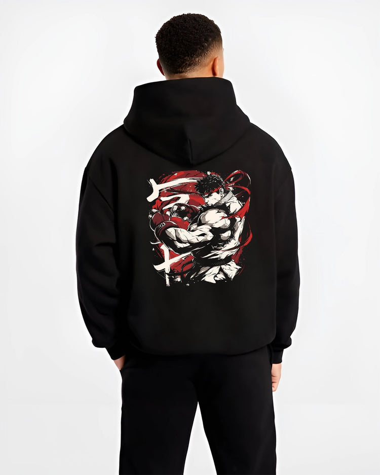 Black hoodie worn by a male model, back view, featuring Ryu Street Fighter retro video game graphic with martial arts stance in Japanese animation streetwear style.