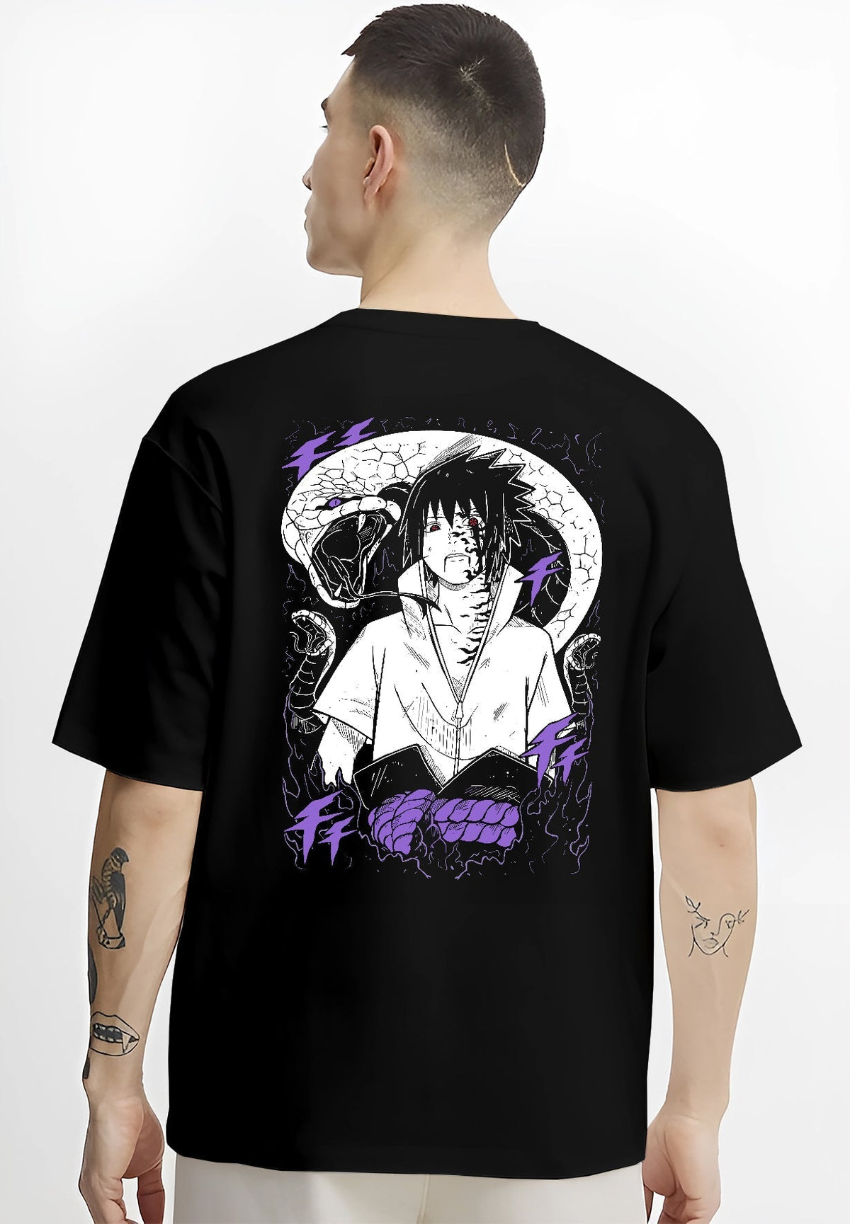 Black T-shirt worn by a male model, back view, featuring Sasuke Naruto dark manga panel artwork with serpent design and shonen battle character inspired detail.