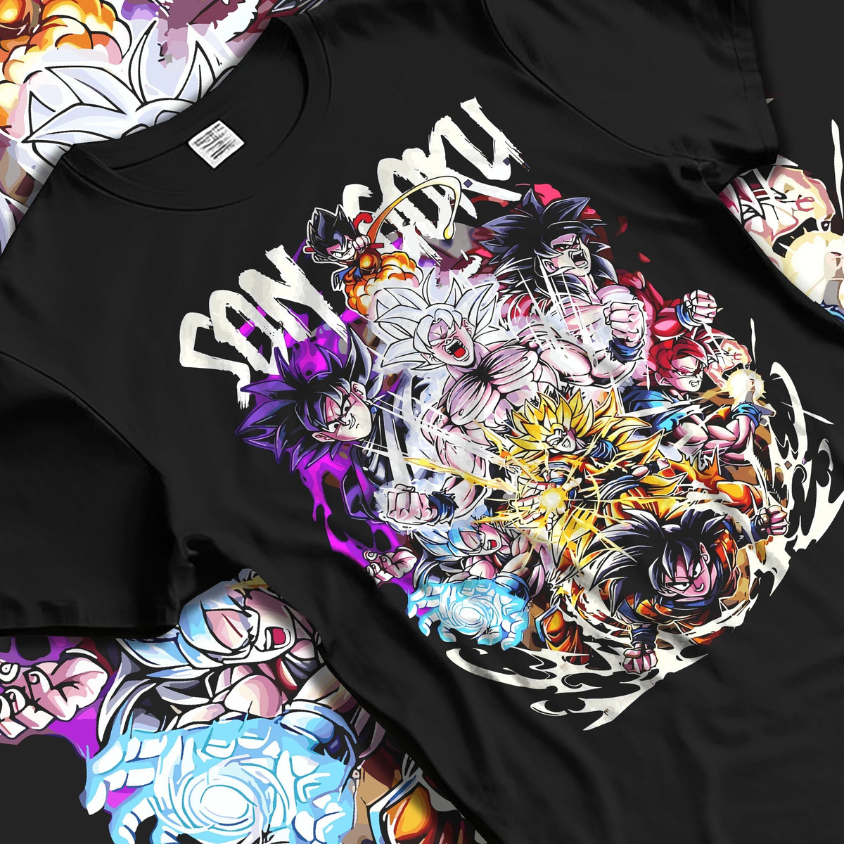 Black T-shirt laid flat with natural fabric folds, featuring Son Goku Dragon Ball shonen battle character artwork with layered transformations in a retro anime style.