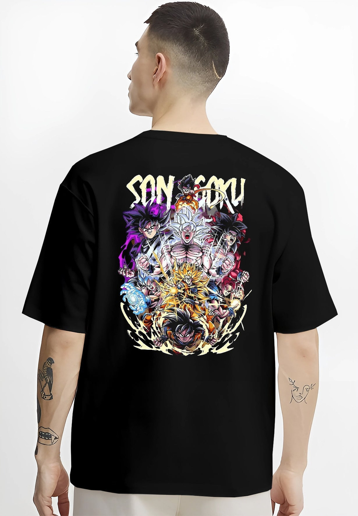 Black T-shirt worn by a male model, back view, featuring Son Goku Dragon Ball anime poster inspired artwork showing legendary battle forms with fiery transformation aura.