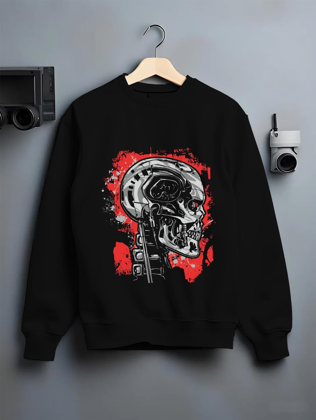 Black crewneck sweatshirt on hanger against a grey wall, featuring Terminator T-800 cyberpunk skull retro sci-fi graphic.
