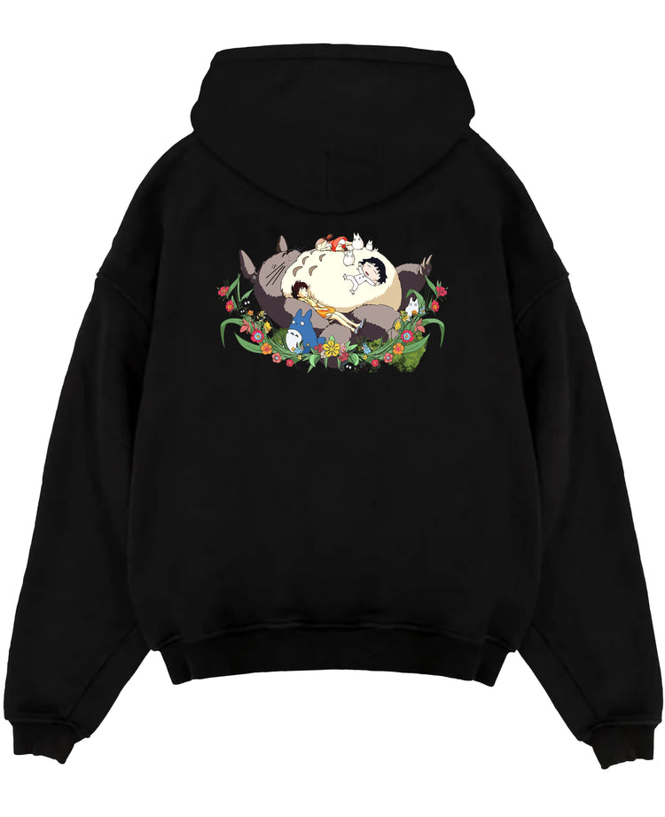 Black pullover hoodie laid flat on white background, featuring Totoro nap scene with friends, nostalgic 90s floral Japanese animation streetwear.