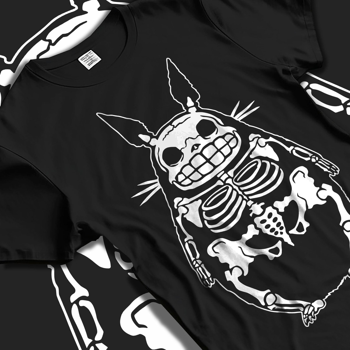 Black T-shirt laid flat with natural fabric folds, featuring Totoro skeleton silhouette, dark manga panel aesthetic and clean minimalist back design.