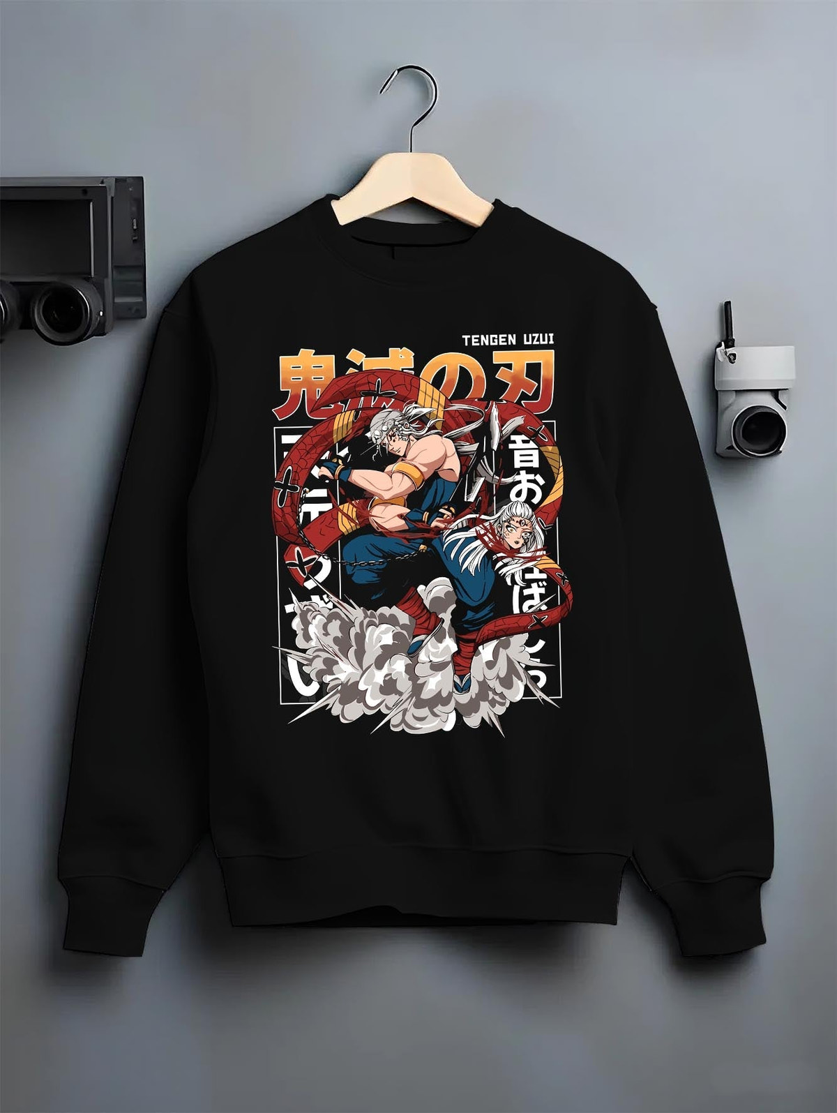 Black crewneck sweatshirt on a hanger against a grey wall, featuring Tengen Uzui modern streetwear graphic with explosive energy and motion.