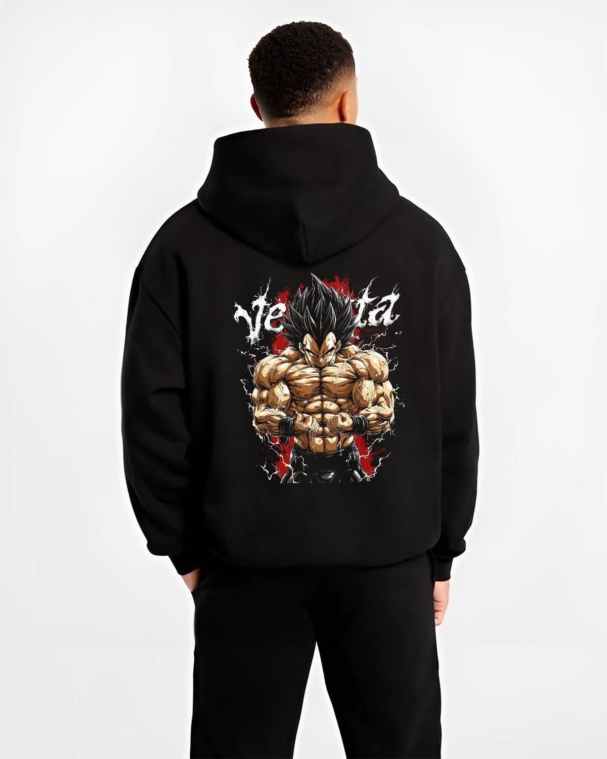 Black hoodie worn by a male model, back view, featuring Vegeta Dragon Ball Z retro manga graphic with bold shonen character art in powerful battle stance.