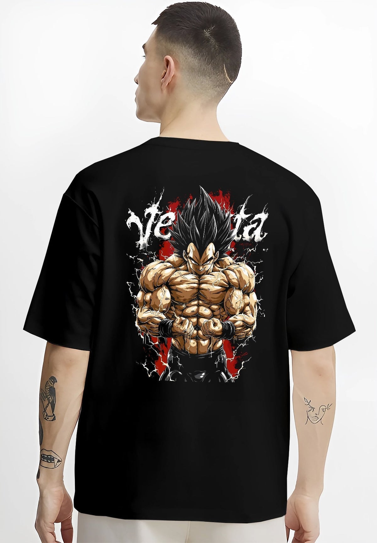 Black T-shirt worn by a male model, back view, featuring Vegeta Dragon Ball Z anime poster inspired graphic with detailed shonen battle character and bold red tones.