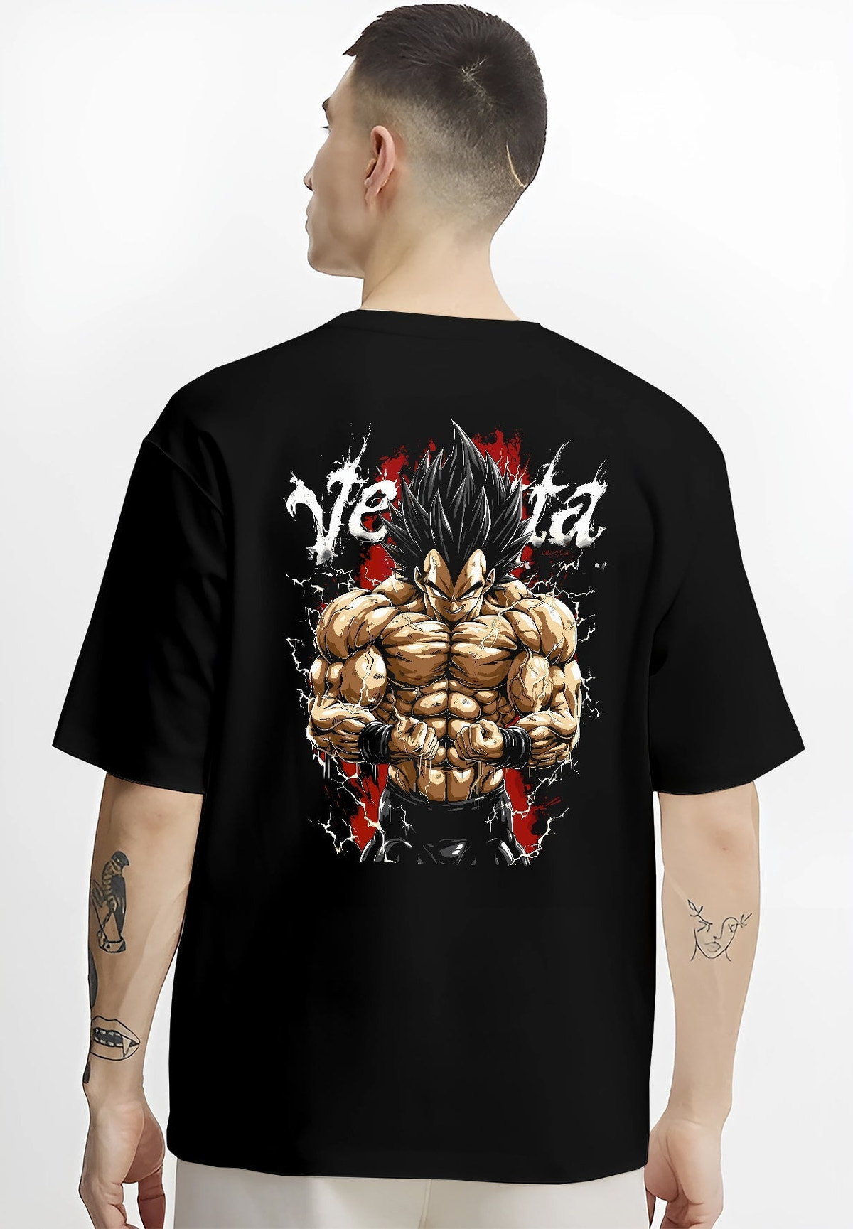 Black T-shirt worn by a male model, back view, featuring Vegeta Dragon Ball Z anime poster inspired graphic with detailed shonen battle character and bold red tones.