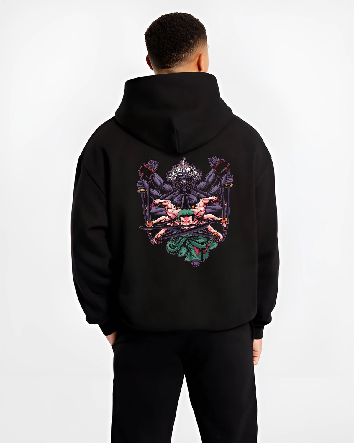 Black hoodie worn by a male model, back view, featuring Zoro One Piece retro manga graphic with demon aura and Japanese animation streetwear shonen battle style.